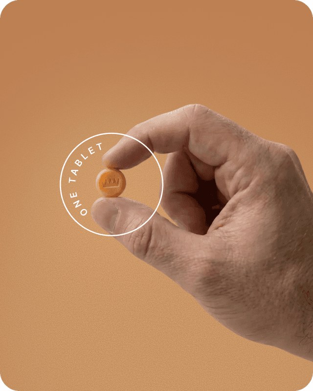 Hand holding a Keeps tablet against a warm tan background